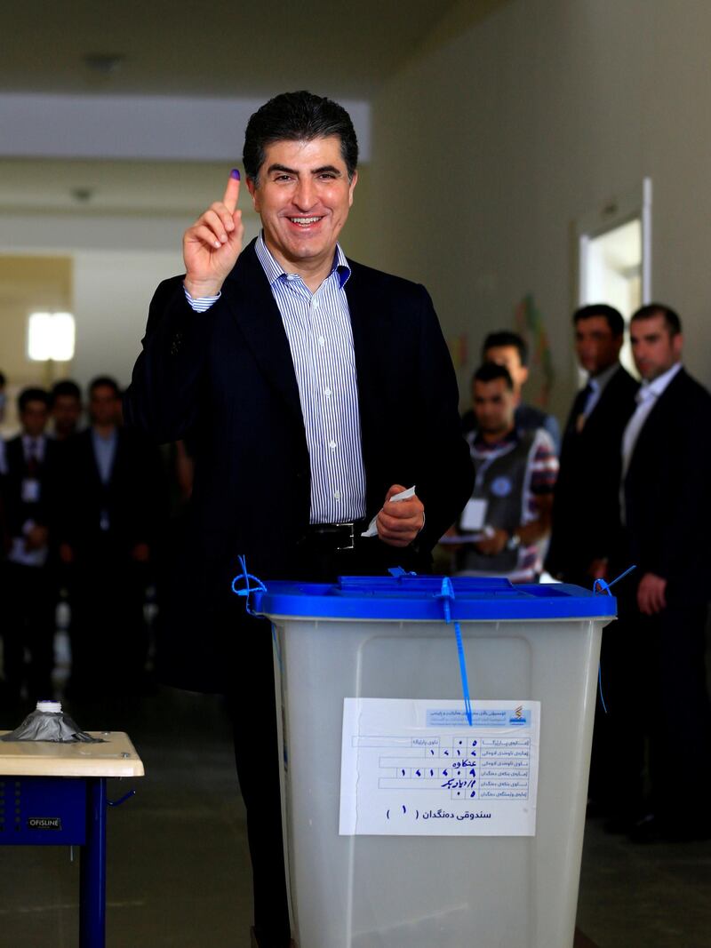FILE PHOTO: Kurdistan Regional Government Prime Minister Nechirvan Barzani shows his ink-stained finger after casting his vote at a polling station during parliamentary elections in the semi-autonomous region in Erbil, Iraq September 30, 2018. REUTERS/Thaier Al-Sudani /File Photo