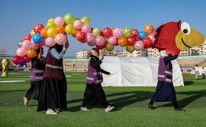 NGO workers take part in the opening ceremony