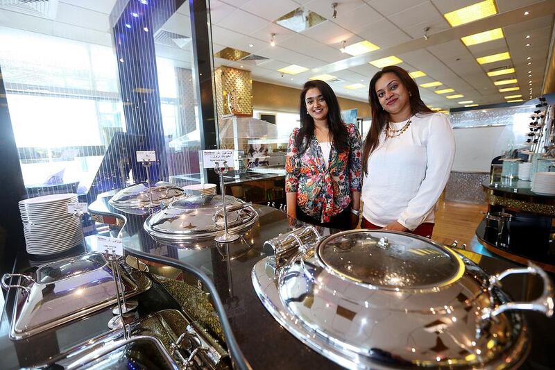 Sisters Deepa, left, and Maya John Marjoran have their hands full ushering in new technology, processes and a brand makeover at the Rainbow Steakhouse. Satish Kumar / The National