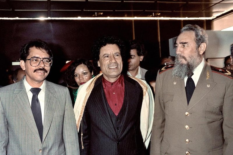 Fidel Castro with Libyan leader Muammar Qaddafi, centre, and Nicaraguan president Daniel Ortega during the non-aligned countries summit in Harare, Zimbabwe, on September 4, 1986. Alexander Joe / AFP