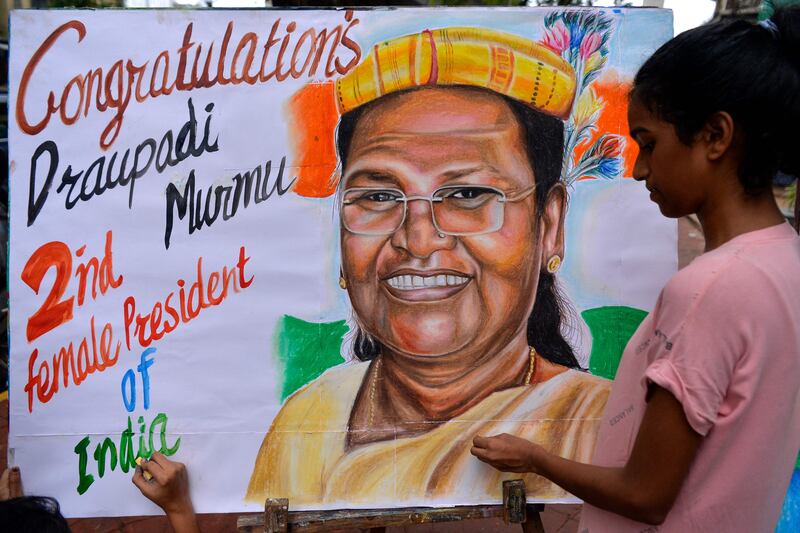 An art school student puts the final touches to a painting of Droupadi Murmu, in Mumbai on Thursday. AFP