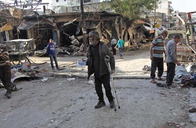 TOPSHOT - A Syrian man whose shop was destroyed in a regime aerial bombardment the  previous day  walks around the area on May 15, 2019 in Jisr al-Shughur in Syria's jihadist-held Idlib province. The regime and its ally Russia have intensified attacks on Idlib and neighbouring Aleppo, Hama and Latakia provinces despite a months-old buffer zone deal intended to shield it from any government offensive. / AFP / Amer ALHAMWE
