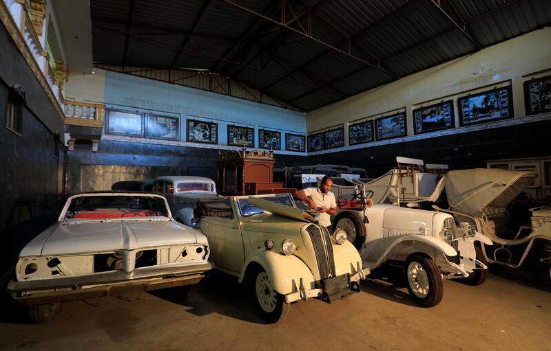 Sima's son, Sayed, 38, checks the battery of a British Standard Flying Eight Tourer - 1948 automobile. Reuters