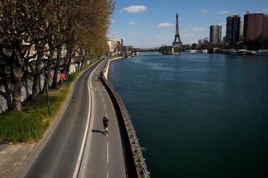 A man jogs along an empty street along the Seine river in Paris. The European Union's leaders are trying to hammer out an agreement for a €1.5 trillion package to help member states struggling with the economic fallout from the coronavirus pandemic, which has hit the continent's tourism industry. AP Photo