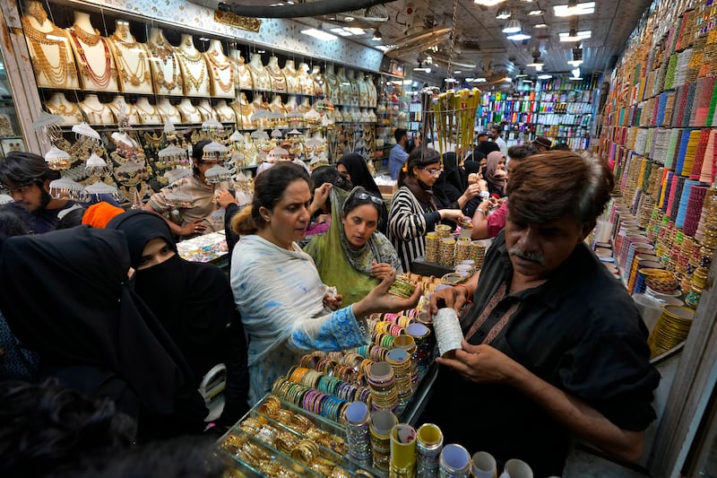 Women visit a market ahead of Eid Al Fitr in Karachi. AP