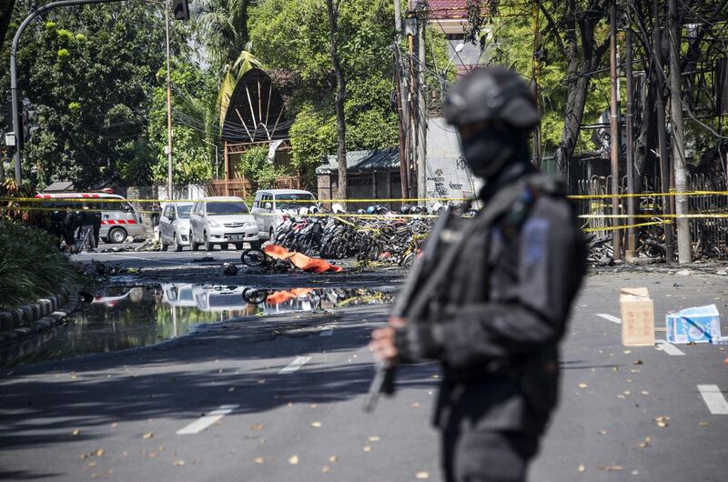 An Indonesian anti-terror policeman stands guard at the blast site following a suicide bomb outside a church in Surabay, East Java, Indonesia. Juni Kriswanto / AFP