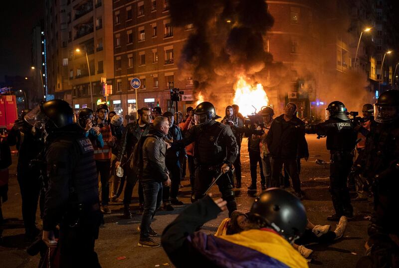 Demonstrators argue with police officers towards the end of a Catalan pro-independence protest outside the Camp Nou stadium. AP