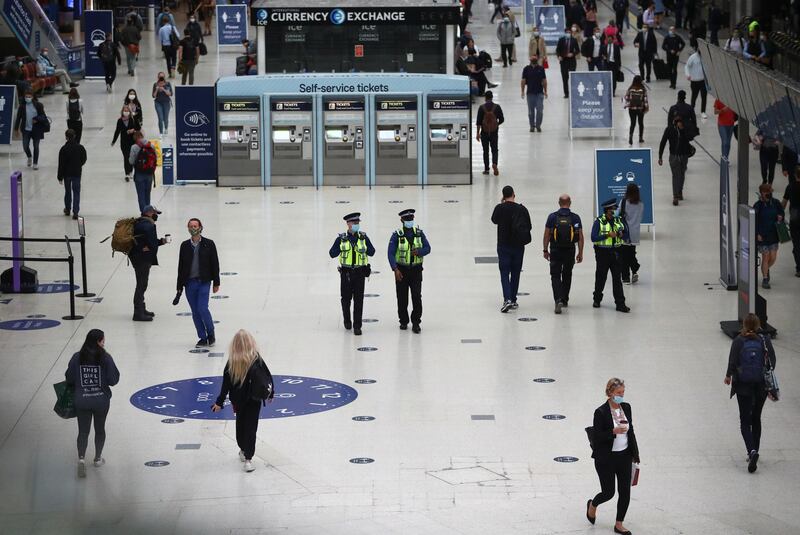 Police officers wearing protective face masks walk through Waterloo station, during the morning rush hour, amid the coronavirus disease (COVID-19) outbreak, in London, Britain, September 23, 2020. REUTERS/Hannah McKay