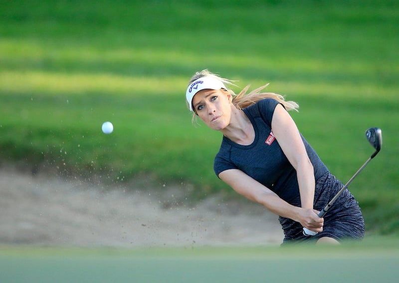 Paige Spiranac of the United States plays her second shot on the par 3, 15th hole during the second round of the 2015 Omega Dubai Ladies Masters on the Majlis Course at The Emirates Golf Club on December 10, 2015 in Dubai, UAE. (Photo by David Cannon/Getty Images)



