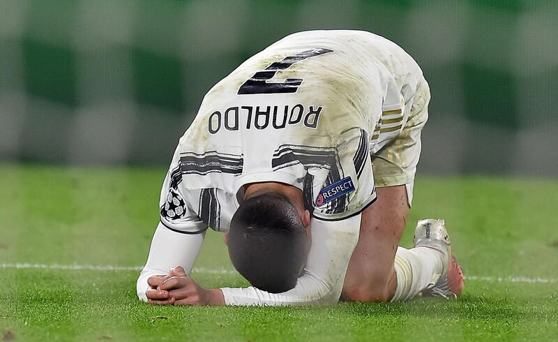 Cristiano Ronaldo slumps to the ground at the end of the match. EPA