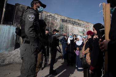 Israeli soldiers and police officers prevent Palestinian women from crossing at Kalandia checkpoint between the West Bank and Jerusalem. EPA