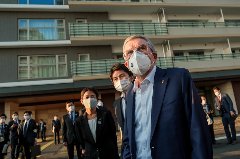 Thomas Bach, International Olympic Committee (IOC) president wearing a protective mask, talks to journalists during a visit to Olympic and Paralympic village in Tokyo, Japan. Reuters