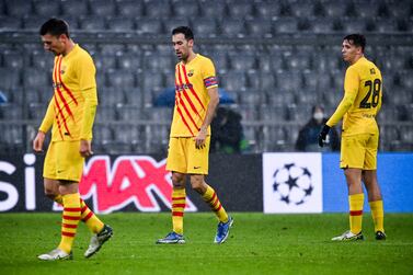 Barcelona's Busquets (C) and his teammates react after losing the UEFA Champions League Group E soccer match between  FC Bayern Muenchen and FC Barcelona at Allianz Arena in Munich, Germany, 08 December 2021.   EPA / PHILIPP GUELLAND