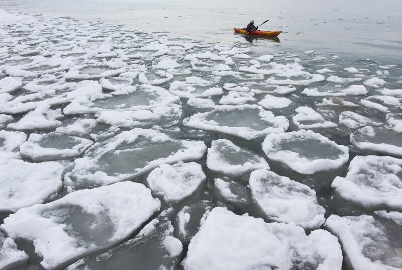 A kayaker paddles past a field of Lake Michigan ice off the shores of St Joseph in the US. AP