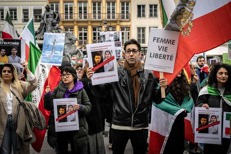 Protesters in France hold images of two other Iranian men, Mohammad Mehdi Karami, left, and Seyed Mohammad Hosseini, who were executed by the regime on Saturday. AFP