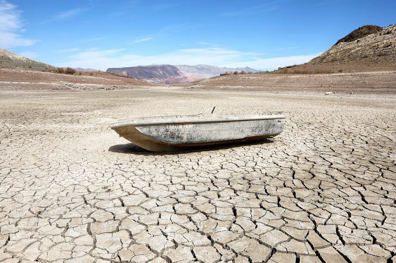 A sunken boat rests on a section of dry lakebed along drought-stricken Lake Mead, in the Lake Mead National Recreation Area of Nevada, US.  AFP