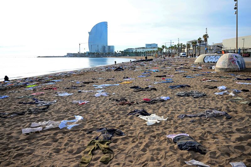 The Spanish NGO Proactiva Open Arms displays clothes at San Sebastian Beach, Barcelona, to draw attention on the migrants dying at sea, on December 11. AFP