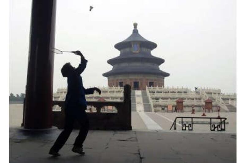 A woman plays badminton in the park at the Temple of Heaven in Beijing.