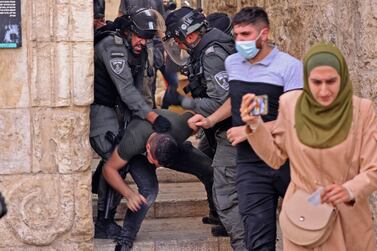 Israeli security forces detain a Palestinian protester amid clashes at the Damascus Gate in Jerusalem's Old City on May 10, 2021, ahead of a planned march to commemorate Israel's takeover of Jerusalem in the 1967 Six-Day War. / AFP / EMMANUEL DUNAND