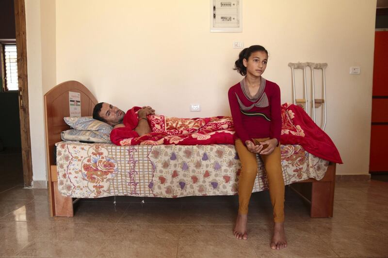 14-year-old Riham Qudaih and her father Ismael in their family home in Khan Younis in Gaza, June 6, 2018. Florian Neuhof / The National