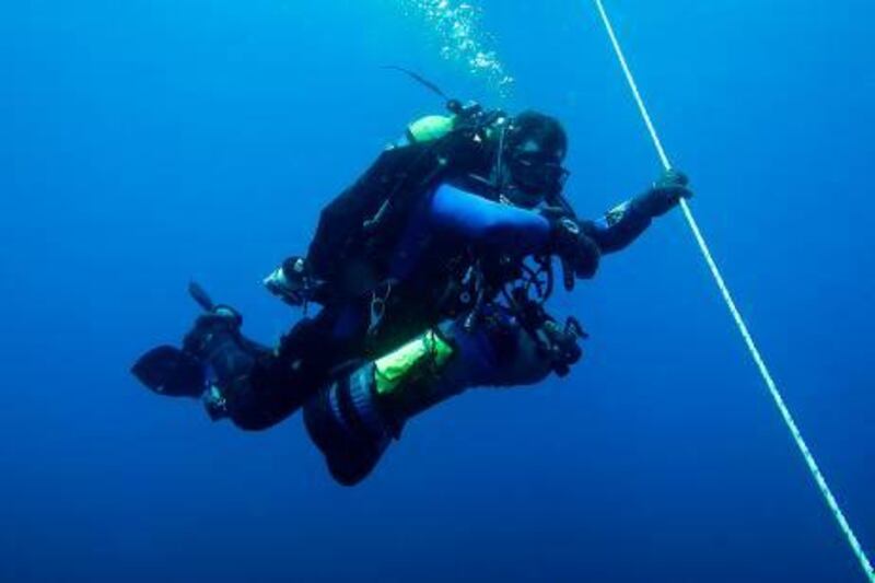 May 27,  Deep diver Peter Brett steadies himself on the anchor line while he waits on his Mandatory Decompression Obligation, a stop in the water at a certain depth based on the depth and the time of his dive, after coming up from a depth of 70 meters. He carefully monitors his dive computer to calculate his decompression tim . May 27, 2011 Fujeirah, United Arab Emirates (Photo: Antonie Robertson/The National)