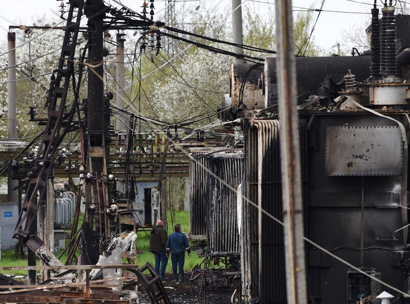 Workers inspect a damaged electric substation in the western city of Lviv, Ukraine. AFP