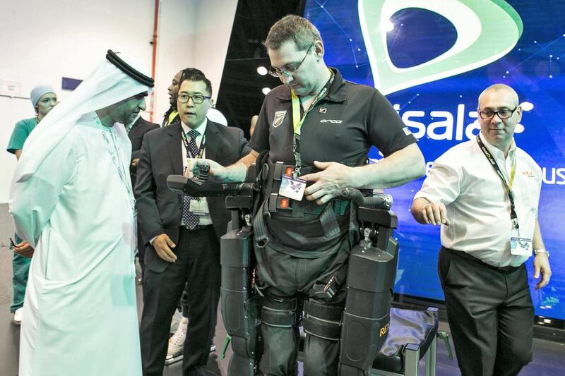 Kiwi Lee Warn demonstrates the Rex walker, a robotic exoskeleton, at Gitex Technology Week in Dubai. Amana Healthcare wants to bring the device to the UAE to help patients. Reem Mohammed / The National  