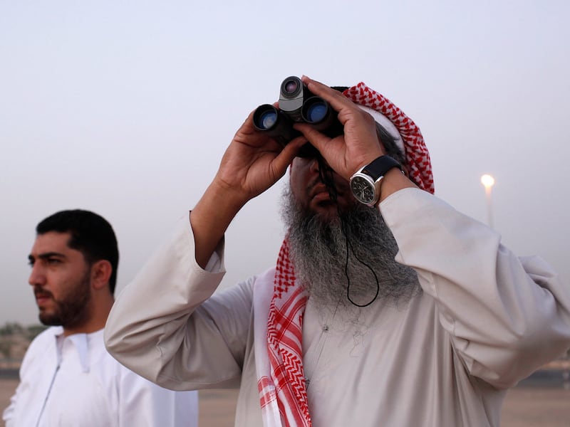 DUBAI, UNITED ARAB EMIRATES - August 21, 2009: (right) Hasan Ahmad Al Hariri, and (left) Ghassan Al Rafati of the Dubai Astronomy Group try to see the moon for the beginning of Ramadan. ( Ryan Carter / The National ) Note: they DID NOT see the moon  *** Local Caption ***  RC005-MoonSighting.jpg