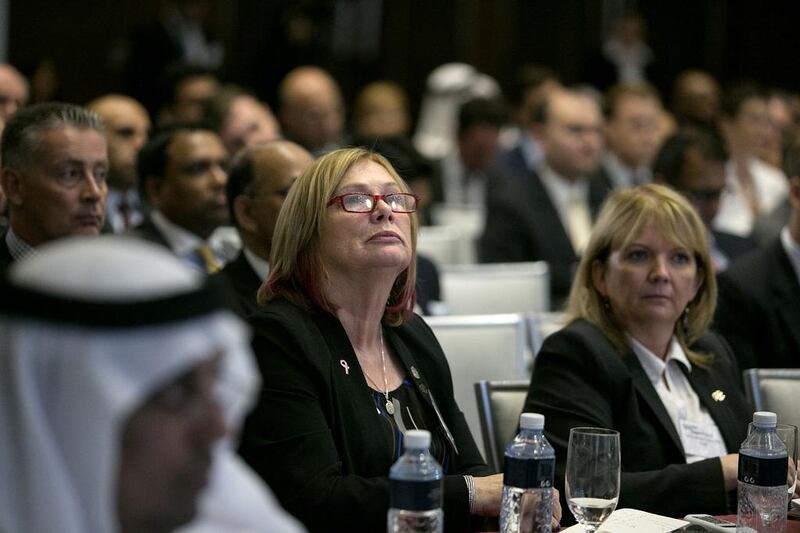 Noeleen Saeed of Abu Dhabi Holding, centre, listens in to a panel discussion during the 6th Annual Global UAE Investment Forum. Silvia Razgova / The National