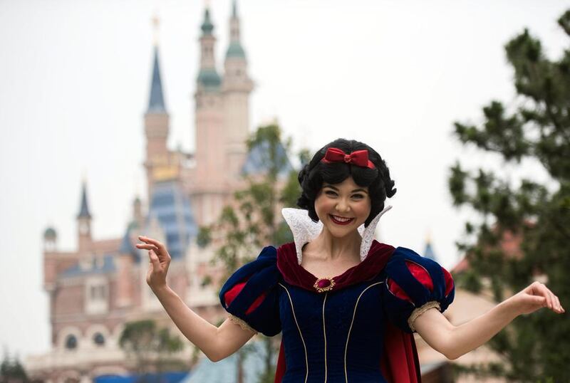 An actress dressed as Snow White in front of the Enchanted Storybook Castle. Disney is betting the growing middle class will spend big on leisure despite a slowing economy. Johannes Eisele/AFP