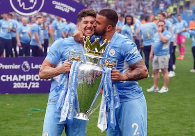 Manchester City's Kyle Walker kisses teammate John Stones after winning the Premier League in 2022. PA