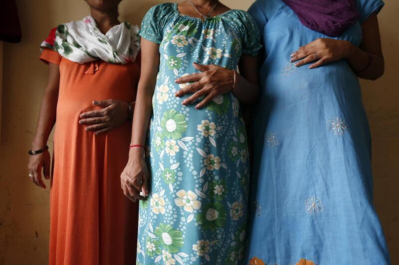 Surrogate mothers Daksha (from left), Renuka and Rajia pose for a photograph inside a temporary home for surrogates provided by Akanksha IVF centre in Anand town, about 70 km south of the western Indian city of Ahmedabad. Mansi Thapliyal/Reuters