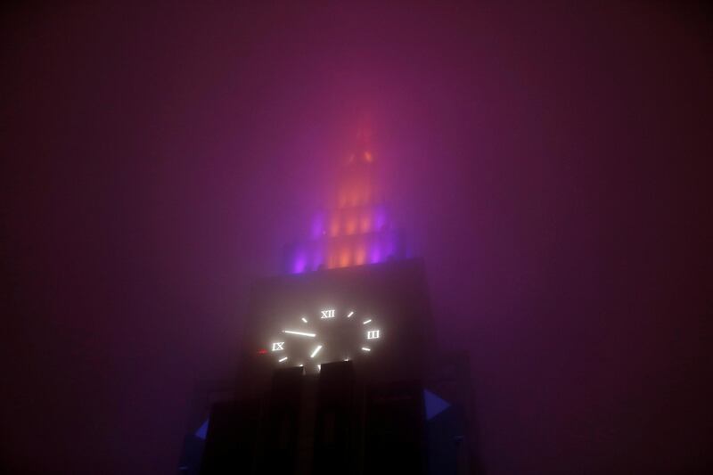 A clock tower building is seen through a foggy rainfall as Typhoon Lan approaches Japan's mainland. Issei Kato / Reuters