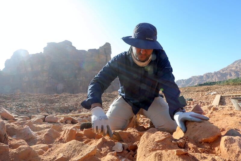 A Saudi archaeologist carefully cleans pottery. Reuters
