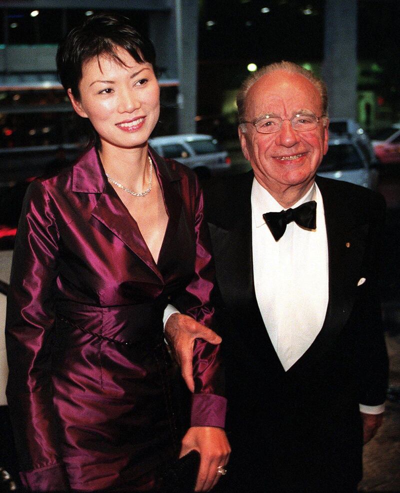 (FILES) This file photo taken on November 8, 1999 shows media magnate Rupert Murdoch (R) and his wife Wendi Deng (L) arriving at the AustralAsia Centre in Sydney to deliver a keynote address. Wendi Deng, who has emerged as an unlikely heroine after leaping to defend her 80-year-old husband Rupert Murdoch from a pie-wielding protester on July 19, 2011, has a reputation for formidable ambition and fierce loyalty.   AFP PHOTO / FILES / Torsten BLACKWOOD
 *** Local Caption ***  454895-01-08.jpg