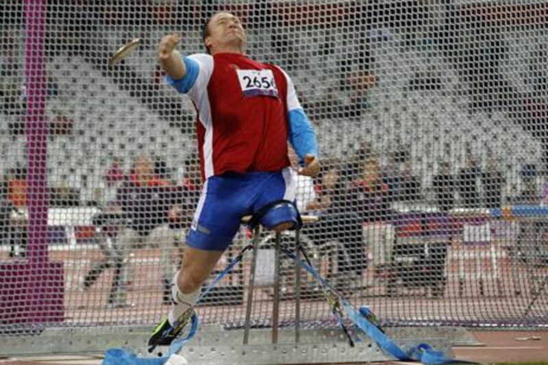 Russia's Alexey Ashapatov breaks the world record in the men's F57/58 discus at the Paralympics