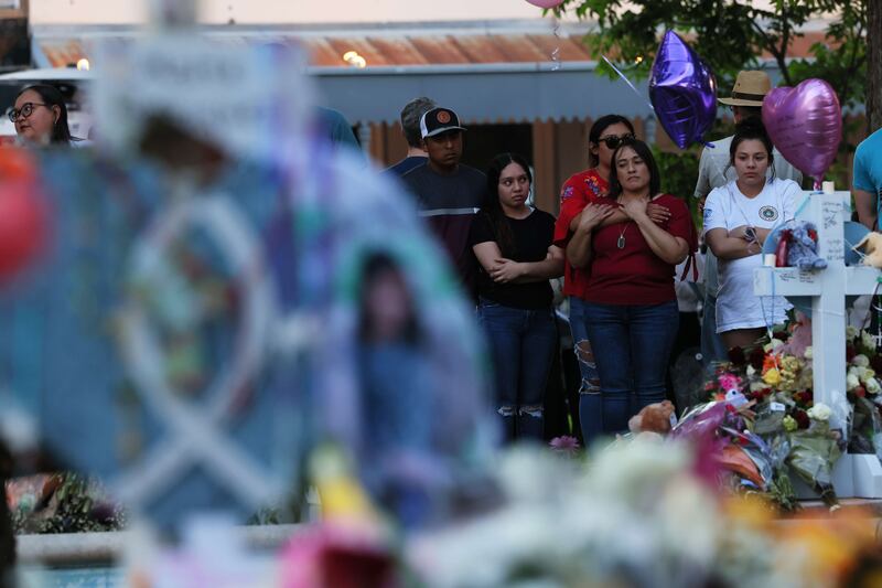 People visit a memorial for the victims. AFP
