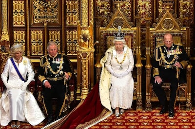 (FILES) In this file photo taken on May 27, 2015 Britain's Queen Elizabeth II (3L) seated on the throne in the House of Lords next to Prince Philip, Duke of Edinburgh (3R), Prince Charles, Prince of Wales (2L) and Camilla, Duchess of Cornwall (L) prepares to deliver the Queen's Speech during the State Opening of Parliament at the Palace of Westminster in London on May 27, 2015.  Britain's Prince Charles turns 70 on November 14, 2018 as busy as ever, having spent a lifetime forging his own path during his record wait for the throne. / AFP / POOL / Ben STANSALL
