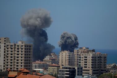 Smoke rises following Israeli airstrikes on a building in Gaza City on May 13. AP