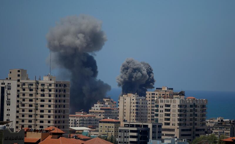 Smoke rises following Israeli airstrikes on a building in Gaza City, Thursday, May 13, 2021.  Gaza residents are bracing for more devastation as militants fire one barrage of rockets after another and Israel carries out waves of airstrikes. (AP Photo/Hatem Moussa)