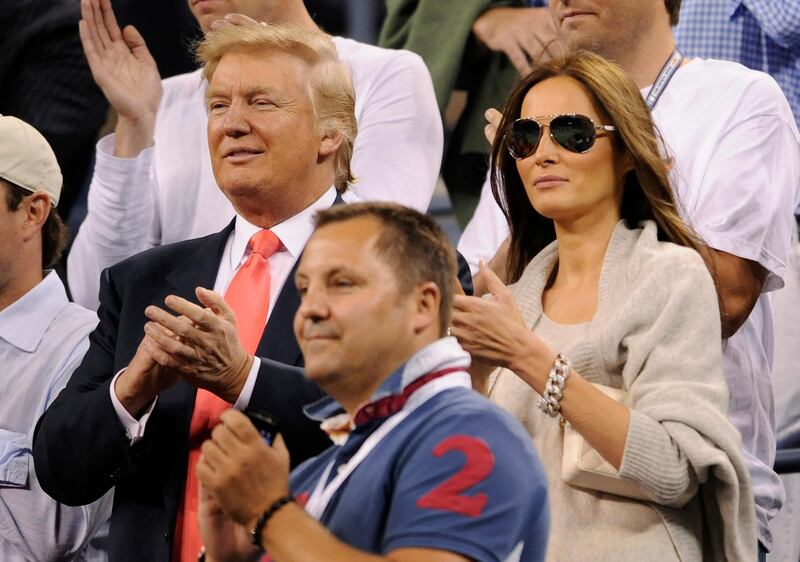 epa02323729 Donald Trump (L) and his wife Melania Knauss (R) applaud after Caroline Wozniacki, of Denmark, defeated Dominika Cibulkova, of Slovakia, during their quarterfinal match at the 2010 US Open Tennis Championship at the USTA National Tennis Center in Flushing, Meadows, New York, USA, on 08 September 2010. The US Open Championship runs through 12 September when the men's final is scheduled to be played.  EPA/JUSTIN LANE
