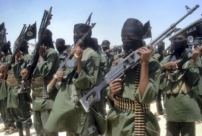 Islamist fighters loyal to Somalia’s Al-Qaida inspired al-Shebab group perform military drills at a village in Lower Shabelle region, some 25 kilometres outside Mogadishu on February 17, 2011. The group claims it has recruited and now training hundreds of new militants to fight against government forces in an expected offensive against militant held positions in the embattled capital following a warning of an attack after 100 days from President, Sheikh Sharrif Ahmed, that are due to expire in a week's time. AFP PHOTO/Abdurashid ABDULLE (Photo by ABDURASHID ABDULLE / AFP)