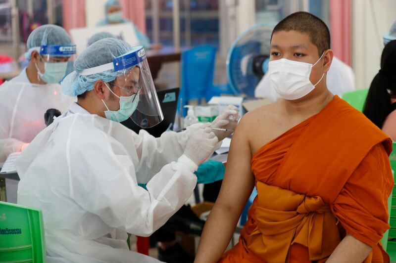 A health worker injects a Buddhist monk with dose of the Sinovac COVID-19 vaccine in Bangkok, Thailand. AP Photo