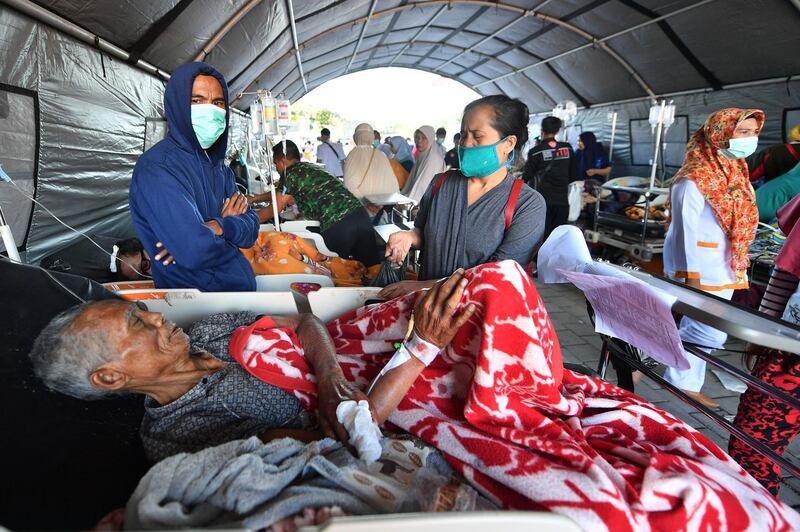 An elderly man rests in a hospital bed at a makeshift ward set up outside the Moh. Ruslan hospital in Mataram on the Indonesian island of Lombok. AFP