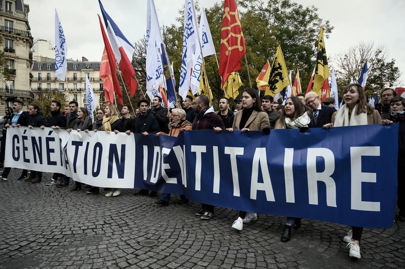 Protesters walk in the street during a demonstration against islamism organised by the far right group Generation Identitaire (GI) in Paris on November 17, 2019. (Photo by Philippe LOPEZ / AFP)