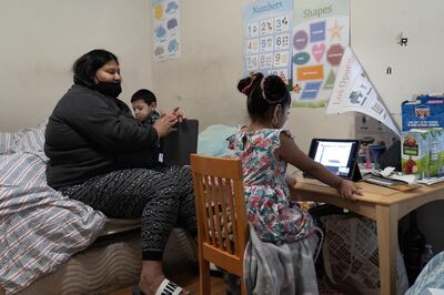 Selena Martinez helps her children Mateo (3) and Natalie (4) with online schooling. Willy Lowry / The National