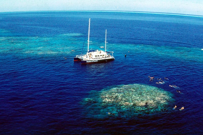In this December, 1999, file photo, tourists snorkel around Upolu Cay on the Great Barrier Reef near Cairns off the Australian north east coast. An aerial survey of the Great Barrier Reef shows coral bleaching is sweeping across the area off the east of Australia for the third time in five years. Bleaching has struck all three regions of the world’s largest coral reef system and is more widespread than ever, scientists from James Cook University in Queensland state said Tuesday, April 7, 2020. AP