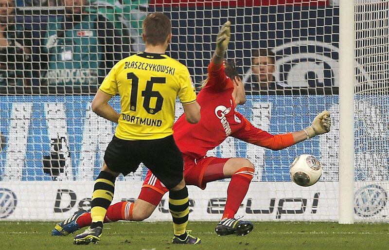 Schalke 1-3 Borussia Dortmund. Jakub Blaszcyzkowski scored Dortmund's third goal as the side remained hot on Bayern's trial, trailing Munich by a point for first place. Frank Augstein / AP