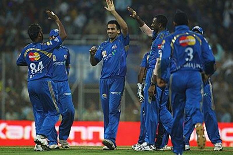 Zaheer Khan, centre, is congratulated by his Mumbai Indians teammates after taking the wicket of Kemar Roach of the Deccan Chargers last week.
