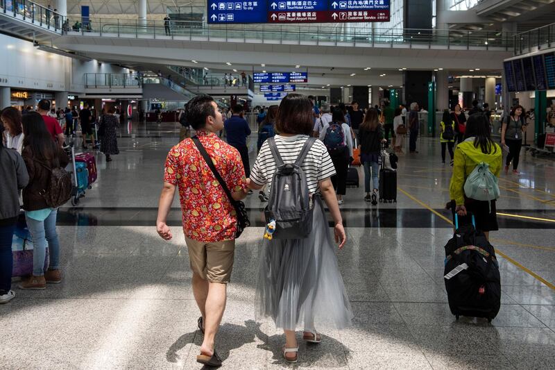 People walk at Hong Kong International Airport, in Hong Kong, China.  EPA